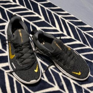 Nike Free Run 5.0 woman’s Running Shoes size 9. Black and Gold. Like new